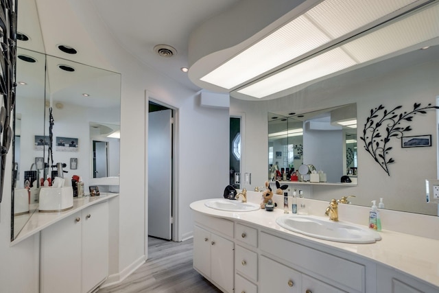 bathroom featuring vanity and wood-type flooring