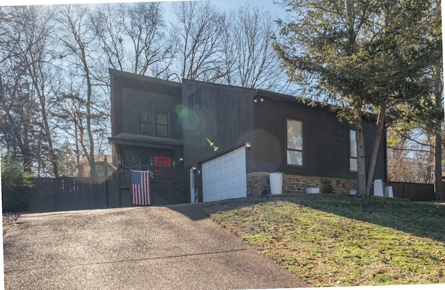 view of front of home with a garage and a front yard