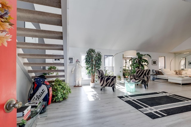 entrance foyer featuring lofted ceiling and hardwood / wood-style floors