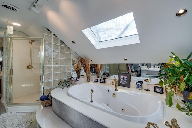 bathroom featuring lofted ceiling with skylight and independent shower and bath