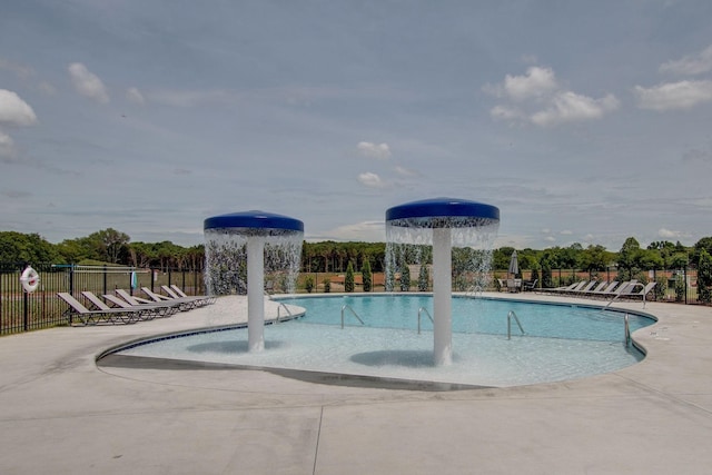 view of swimming pool with a patio and pool water feature