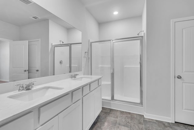 bathroom with vanity and an enclosed shower