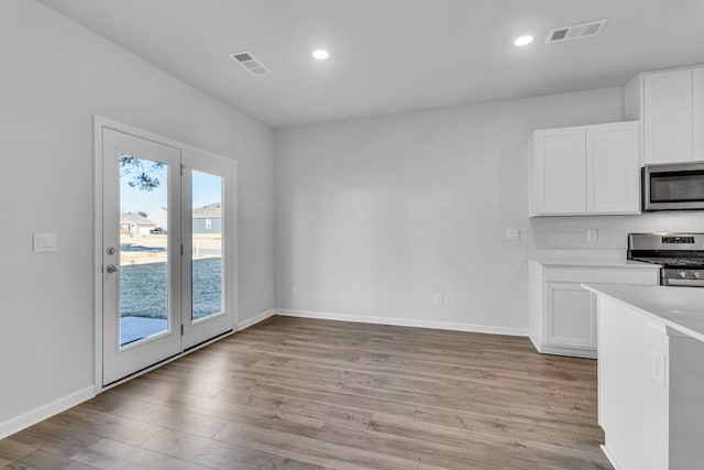 unfurnished dining area with light hardwood / wood-style floors