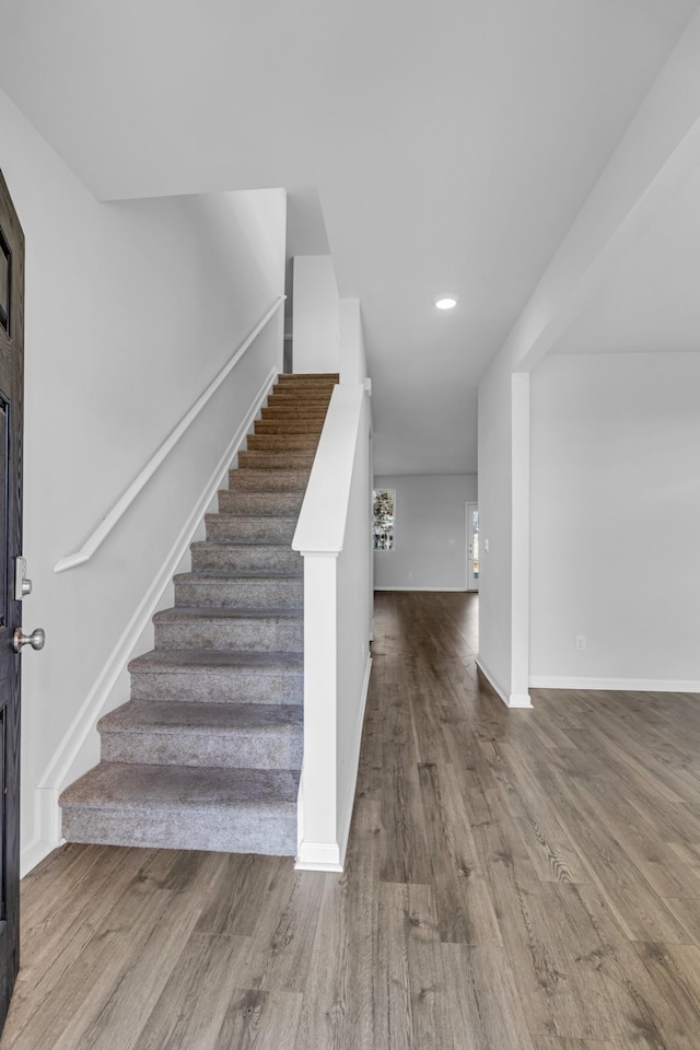 staircase with hardwood / wood-style flooring