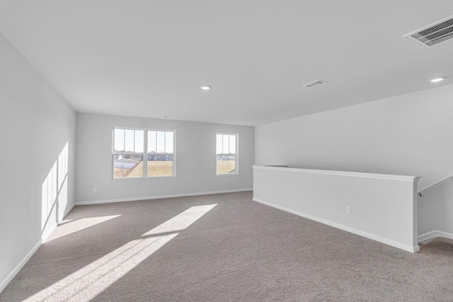 unfurnished room featuring light carpet