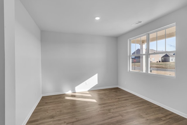 unfurnished room with dark hardwood / wood-style flooring