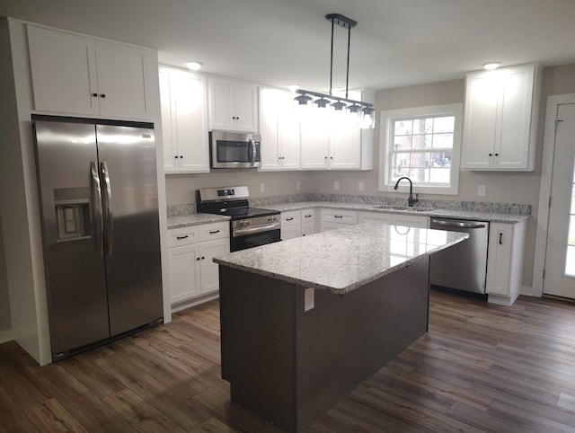 kitchen featuring sink, white cabinetry, a kitchen island, pendant lighting, and stainless steel appliances