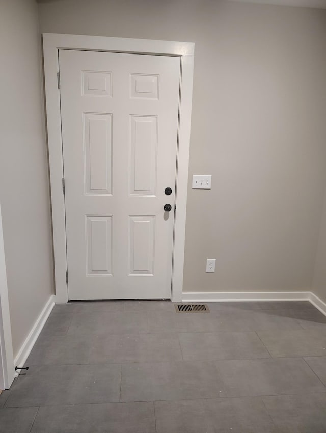 entryway with light tile patterned flooring