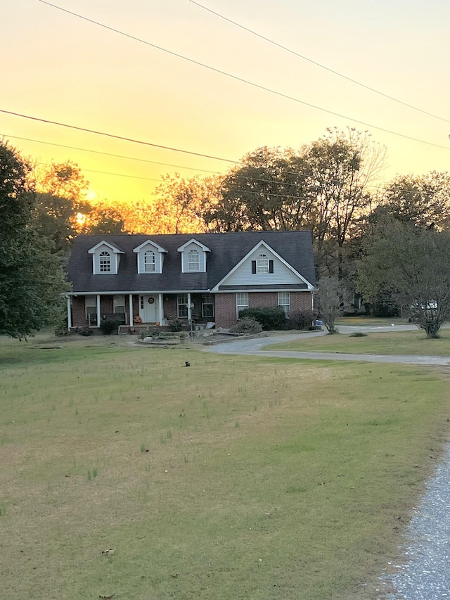 view of front of house with a lawn and covered porch