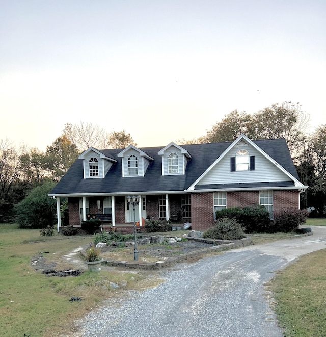 new england style home with a porch