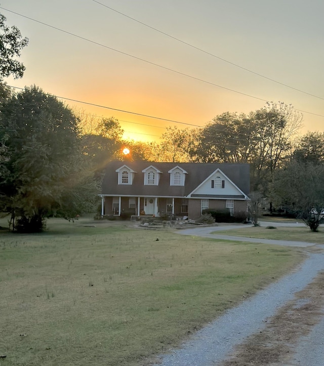 view of front of home with a porch and a yard