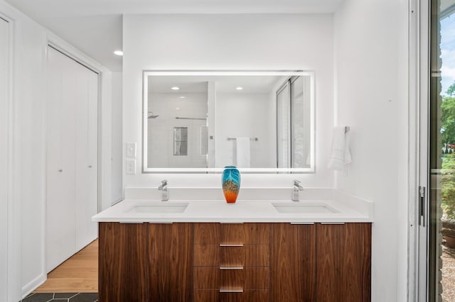 bathroom with vanity, hardwood / wood-style floors, and walk in shower