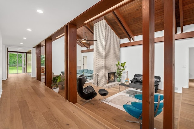 hall featuring high vaulted ceiling, light wood-type flooring, wood ceiling, and beam ceiling