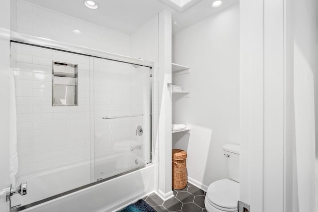 bathroom with tile patterned flooring, enclosed tub / shower combo, and toilet