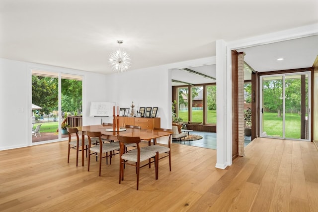 dining room featuring light hardwood / wood-style floors and a notable chandelier