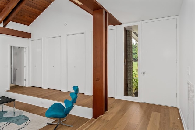 foyer with wooden ceiling, beam ceiling, high vaulted ceiling, and light wood-type flooring