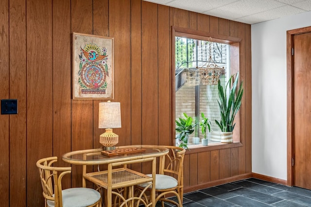 dining area featuring wood walls