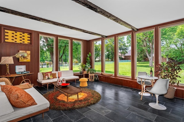 sunroom with plenty of natural light and beam ceiling