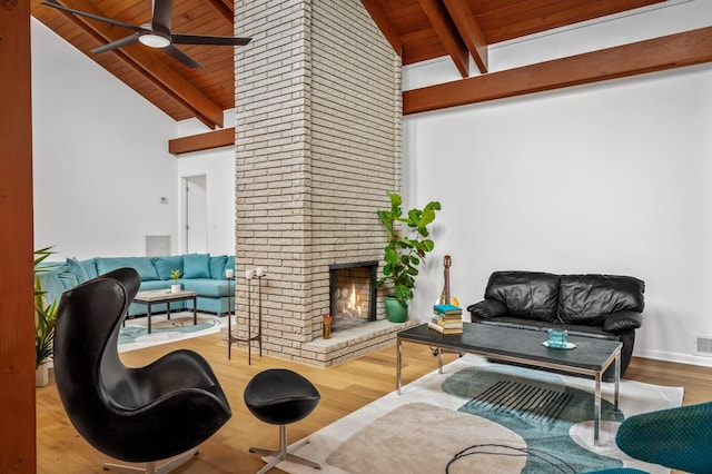 living room with a fireplace, hardwood / wood-style flooring, lofted ceiling with beams, and wooden ceiling