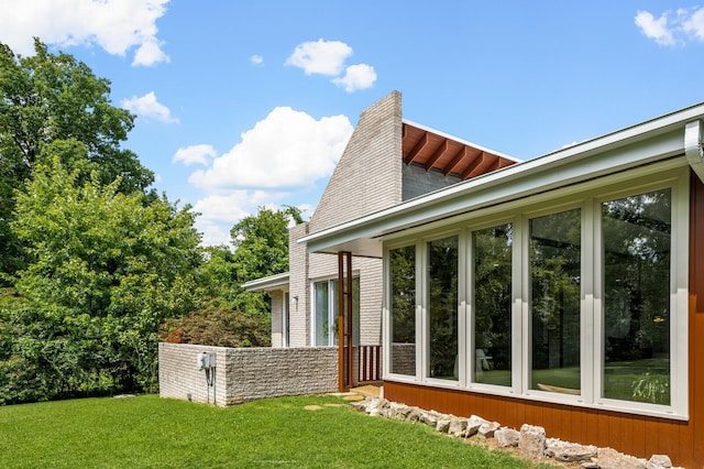 view of side of home featuring a yard