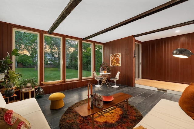 sunroom featuring beam ceiling