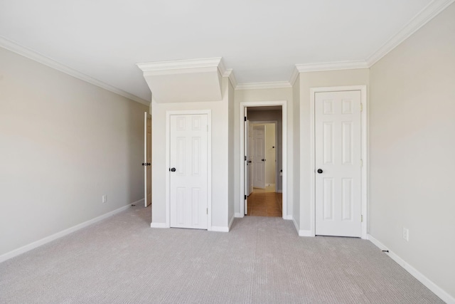 unfurnished bedroom featuring light carpet and crown molding