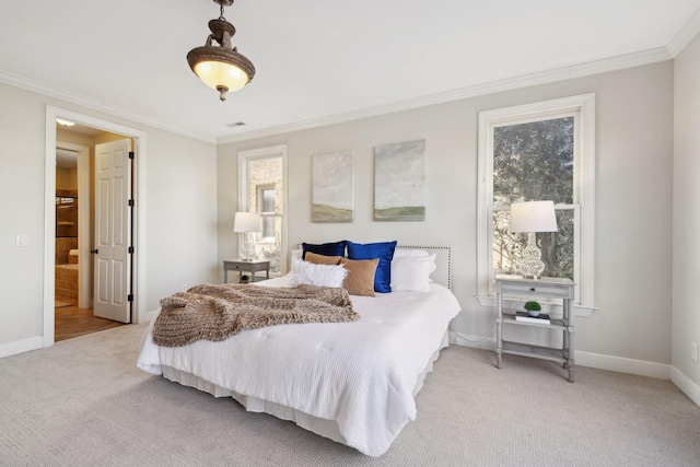 carpeted bedroom with crown molding and ensuite bathroom