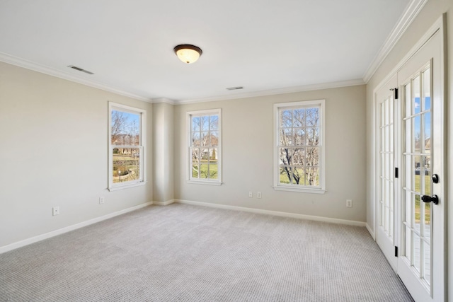 carpeted spare room with crown molding and a healthy amount of sunlight