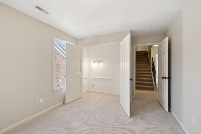 unfurnished bedroom featuring light carpet