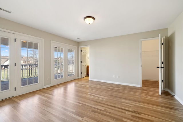 unfurnished room with light hardwood / wood-style floors