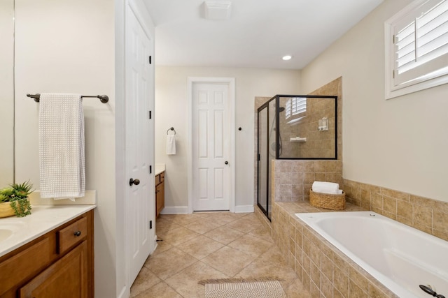 bathroom with tile patterned floors, vanity, and shower with separate bathtub