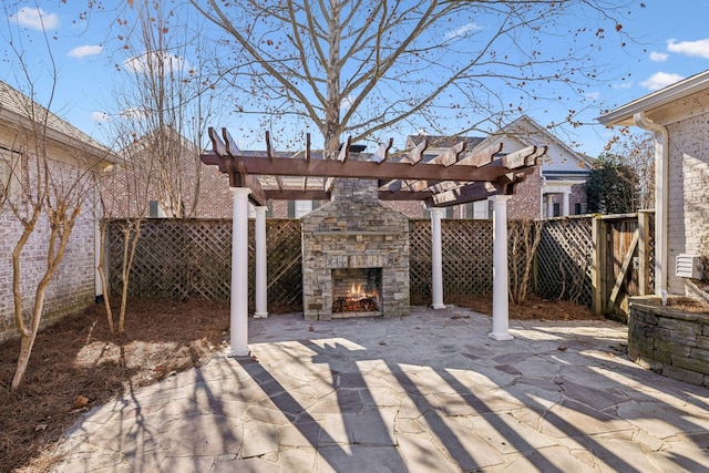 view of patio / terrace featuring an outdoor stone fireplace