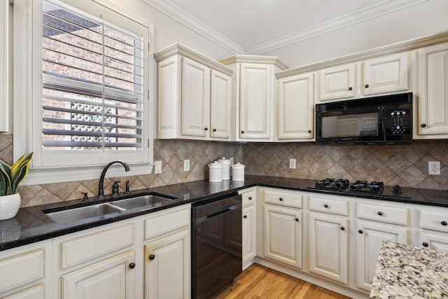 kitchen featuring tasteful backsplash, sink, dark stone counters, black appliances, and crown molding