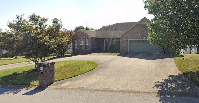 ranch-style house with a garage and a front yard