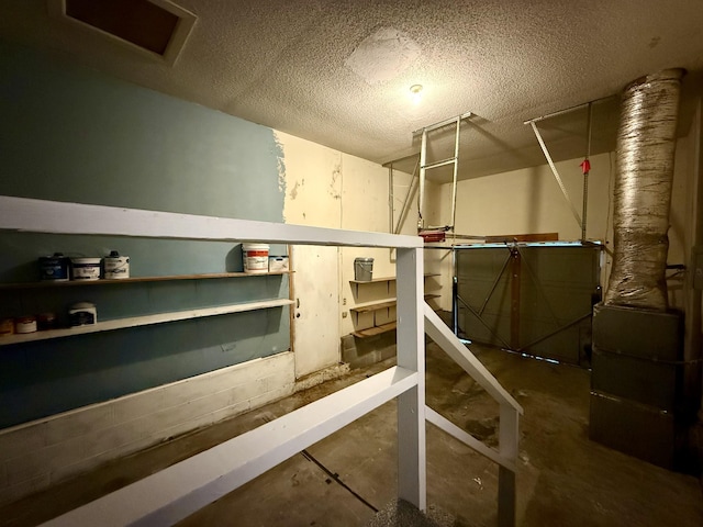 basement featuring a textured ceiling