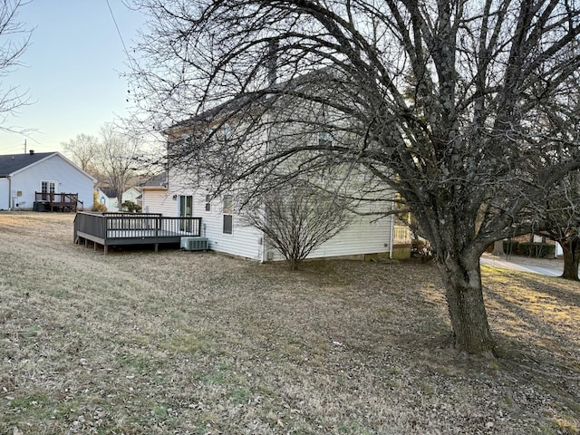 view of yard with cooling unit and a deck