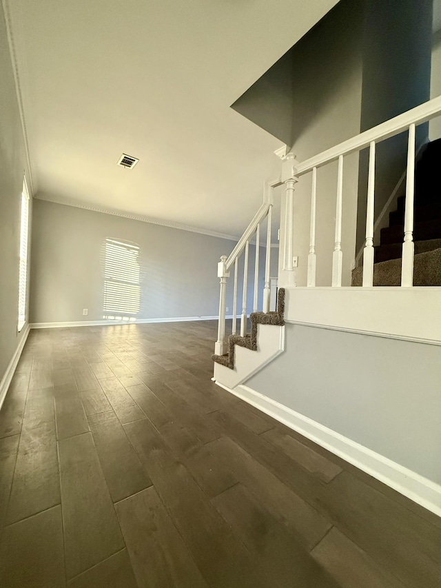 stairs featuring crown molding and hardwood / wood-style flooring