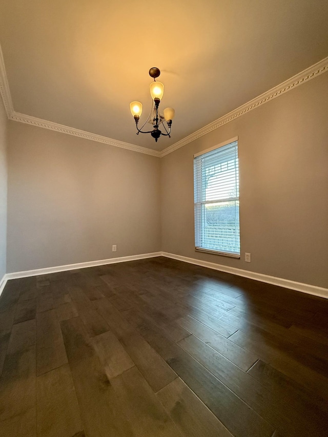 spare room featuring dark hardwood / wood-style flooring and a chandelier