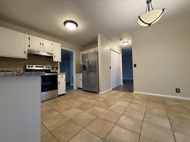 kitchen featuring appliances with stainless steel finishes, pendant lighting, white cabinetry, decorative backsplash, and light tile patterned floors