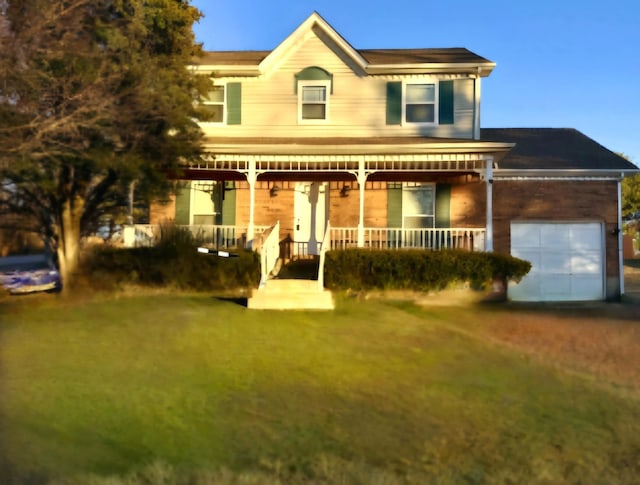 view of front of house featuring a garage, a front lawn, and a porch