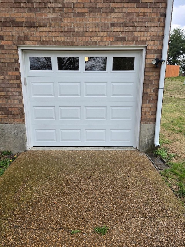 garage featuring concrete driveway