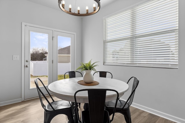 dining space featuring a chandelier and light wood-type flooring