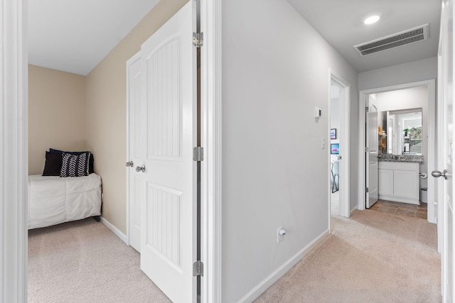 hallway with light colored carpet