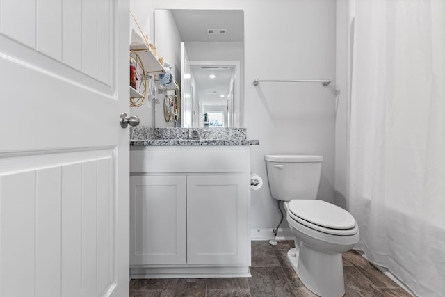 full bathroom featuring vanity, shower / tub combo, and toilet