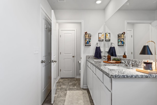 bathroom featuring vanity and toilet