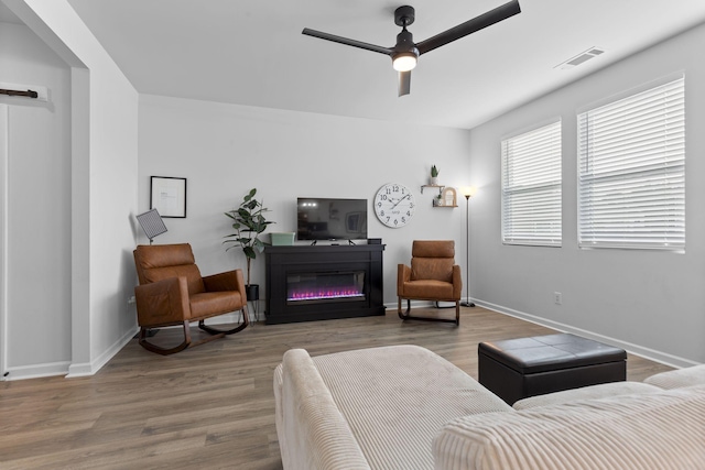 living room with hardwood / wood-style flooring and ceiling fan