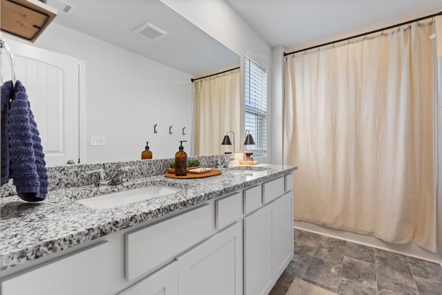 bathroom featuring vanity and shower / tub combo