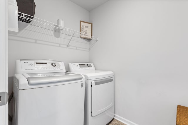 clothes washing area with separate washer and dryer