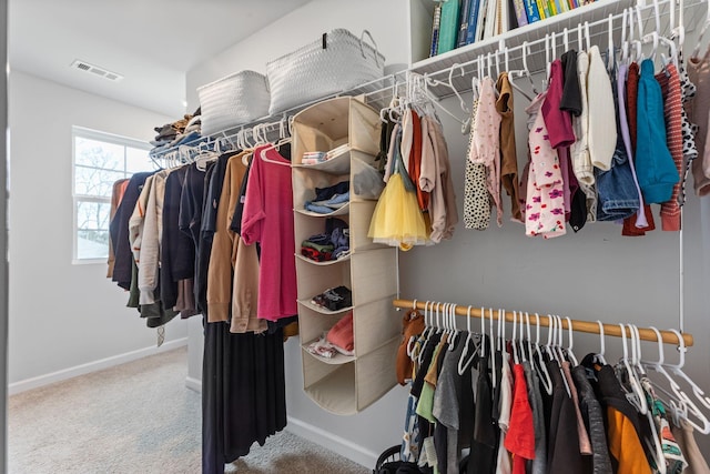 walk in closet featuring carpet