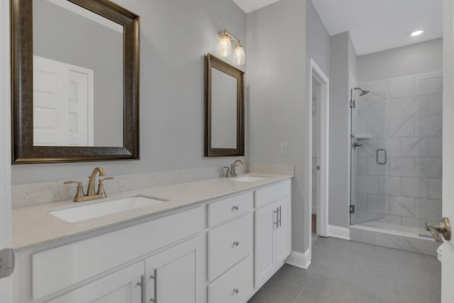 bathroom with vanity, an enclosed shower, and tile patterned floors